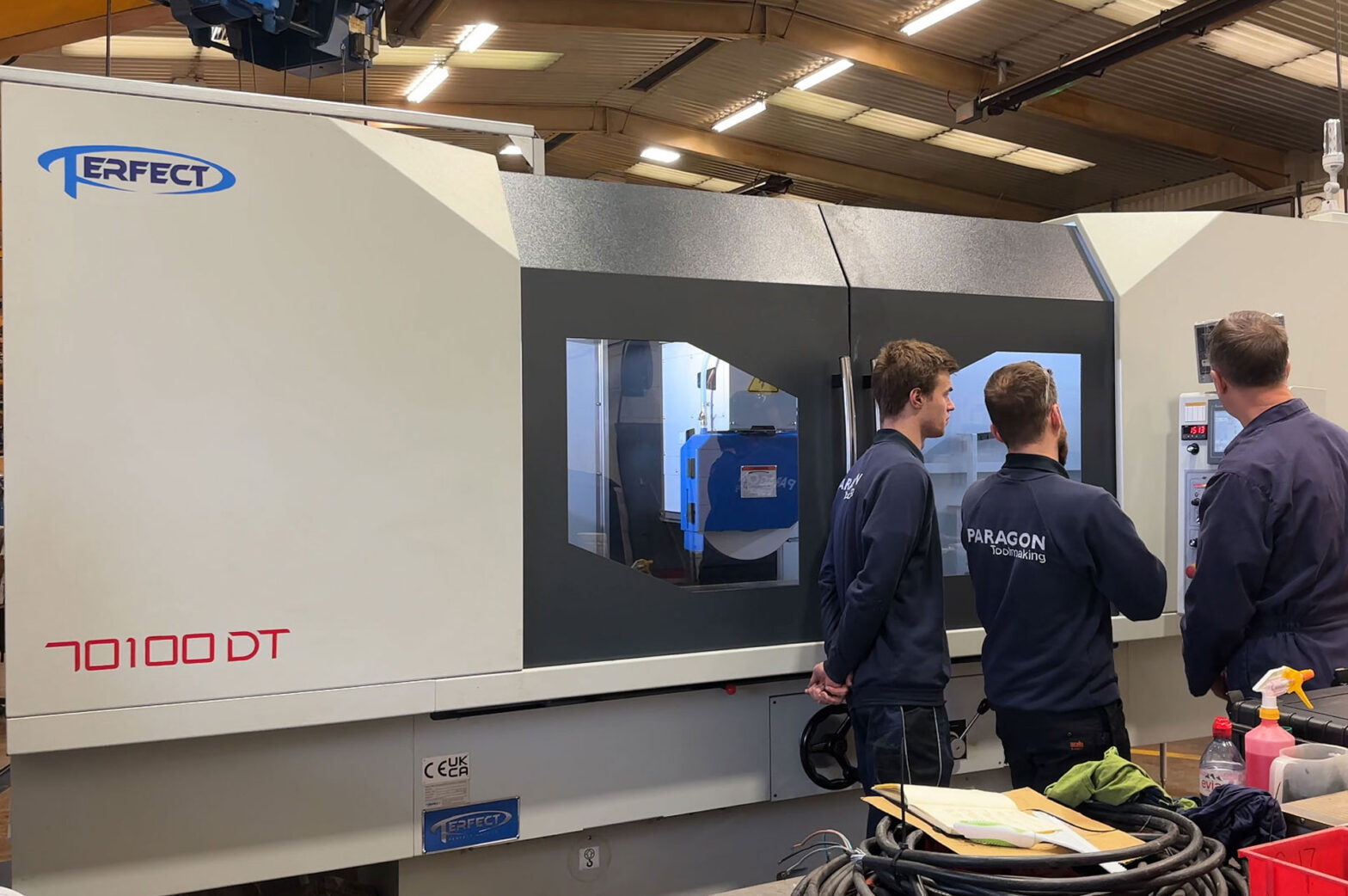 Paragon toolmaking team being trained to use the new CNC grinding machine.